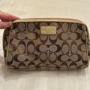 Coach make up bag. Tan canvas with gold coach tag and piping Pink interior. NWOT